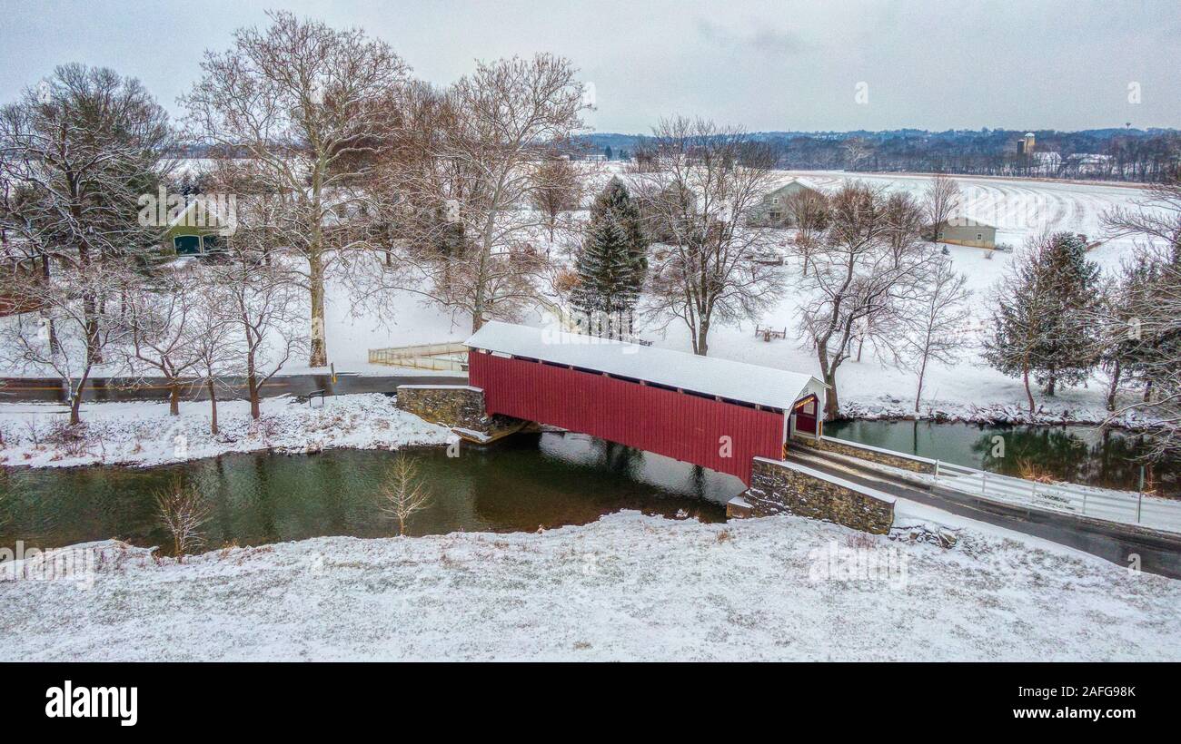 Pennsylvania Covered Bridge, aerial view of red covered bridge across creek, river in Lancaster County, PA Stock Photo