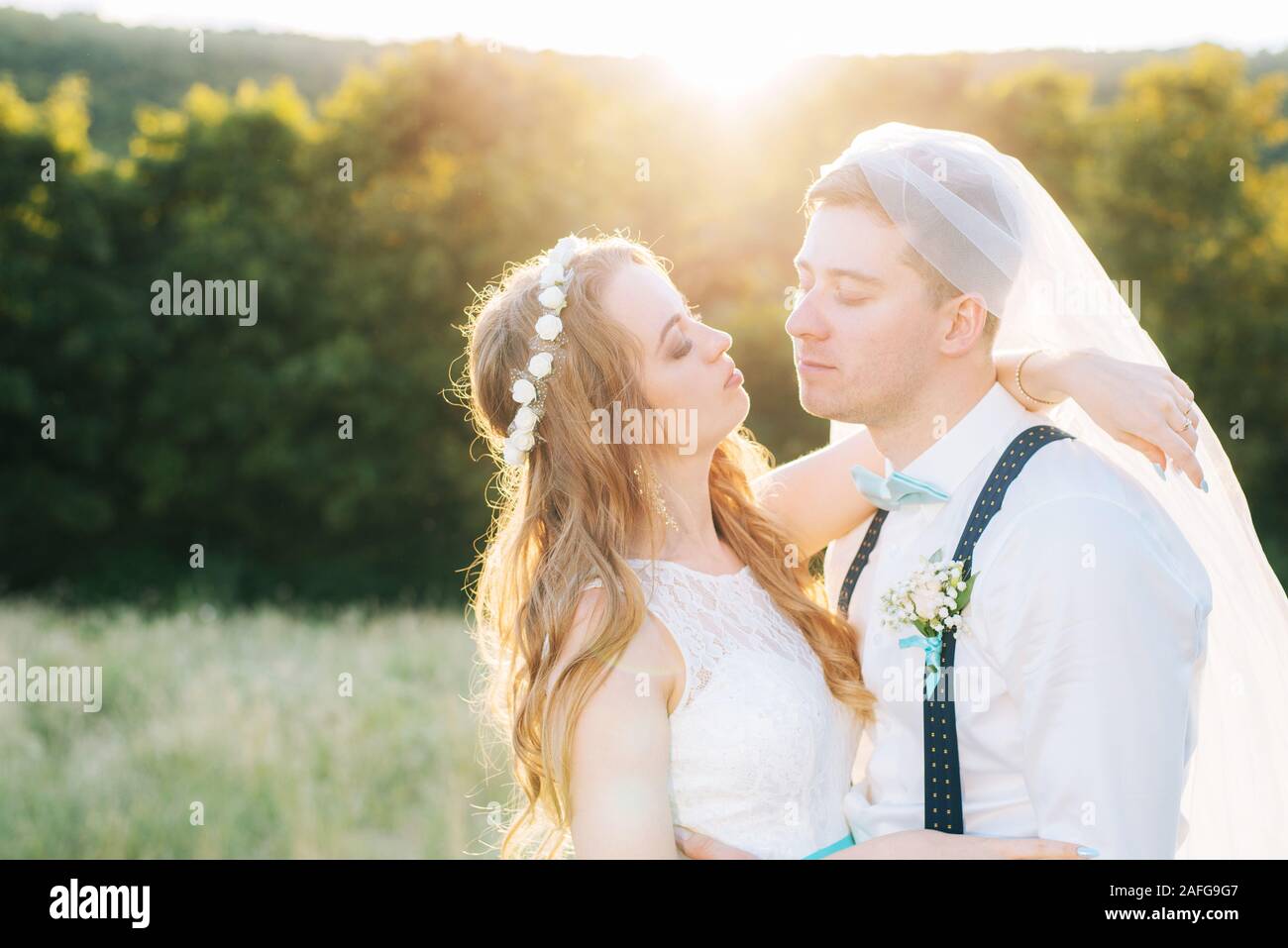 the bride and groom are photographed at sunset Stock Photo - Alamy