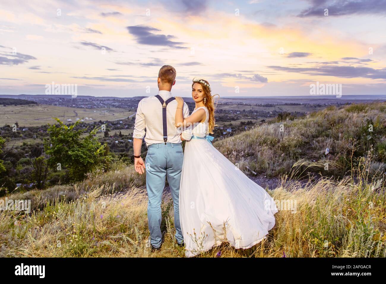 the bride and groom are photographed at sunset Stock Photo - Alamy