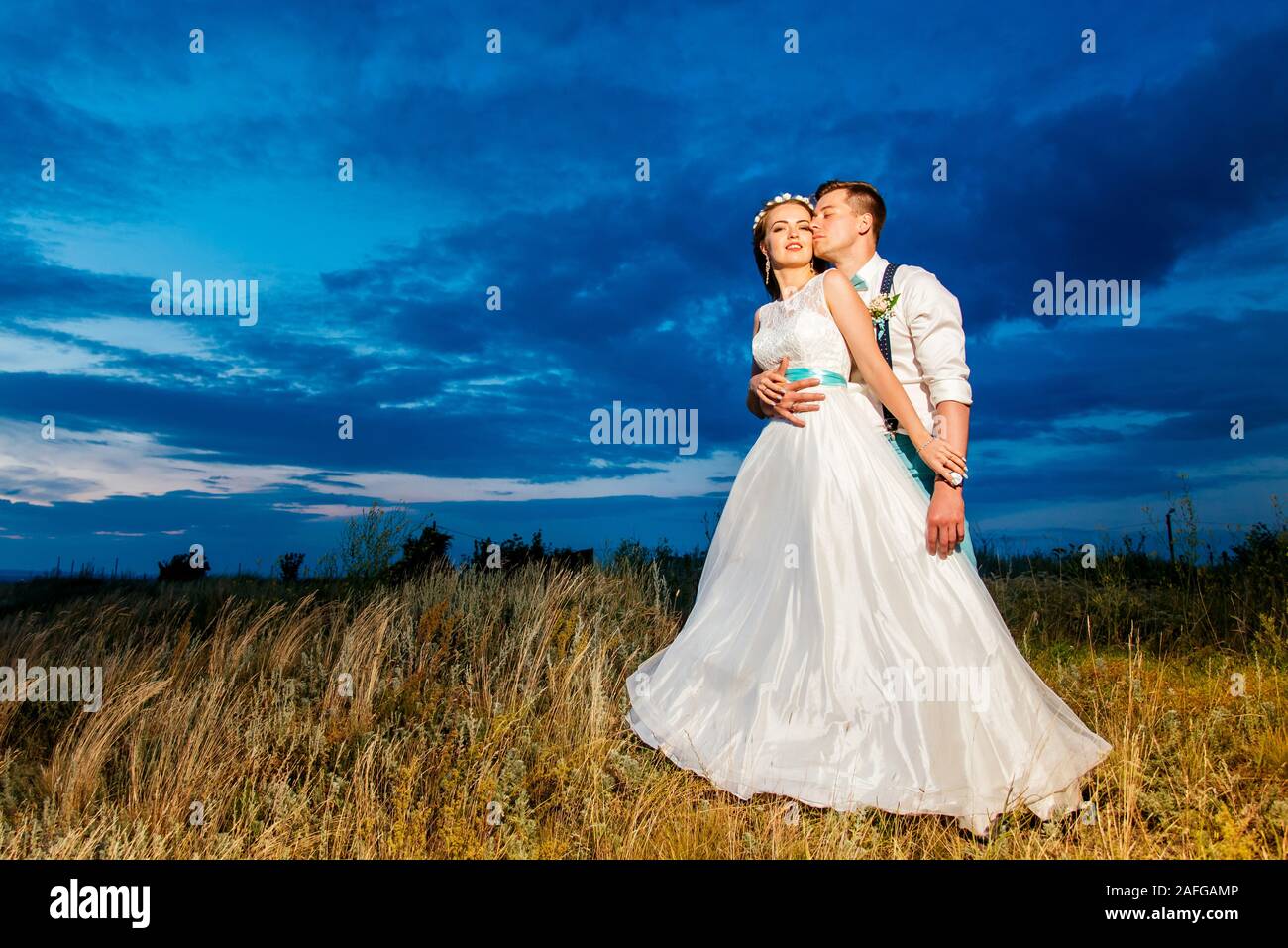 the bride and groom are photographed at sunset Stock Photo - Alamy