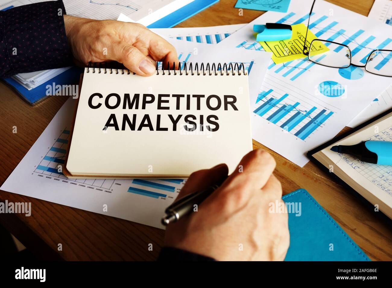 Competitor analysis report in the man hands. Stock Photo