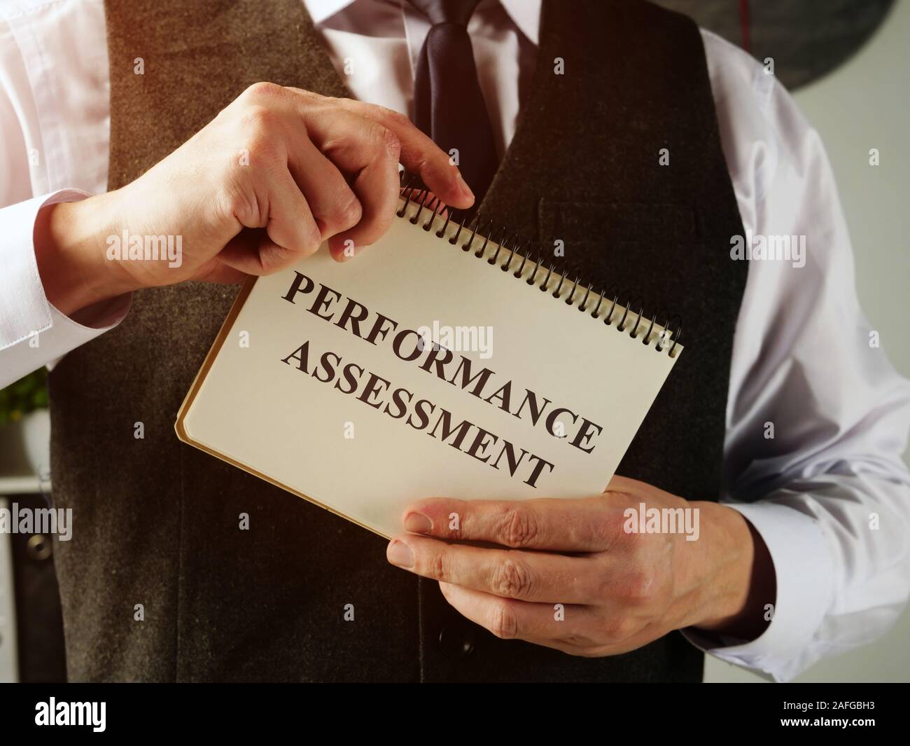 Performance assessment in the hands of a man. Stock Photo