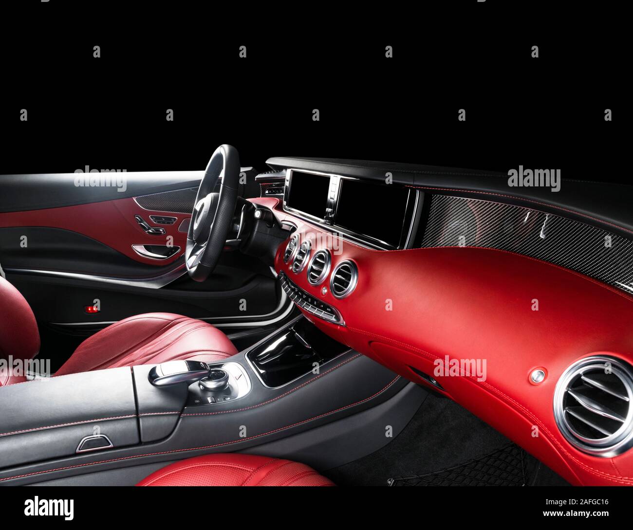Red luxury modern car Interior with steering wheel, shift lever and