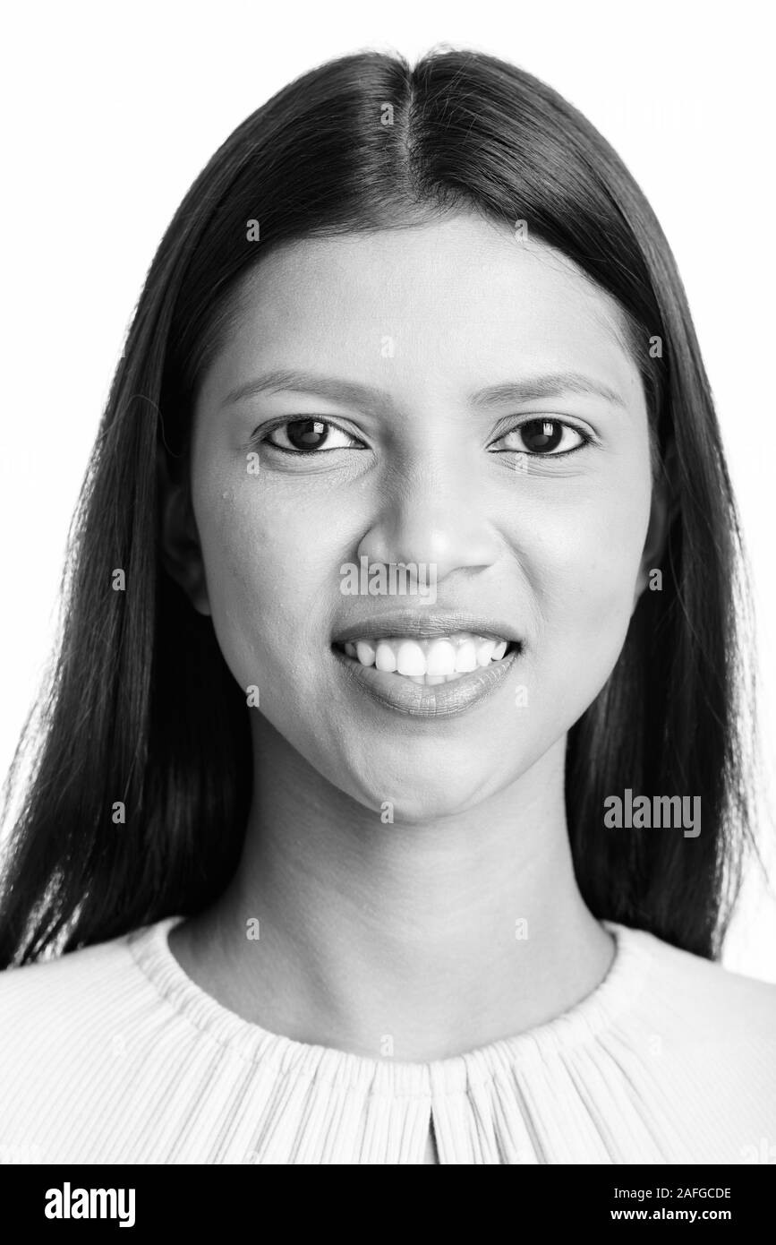 Face of young happy Brazilian woman smiling Stock Photo