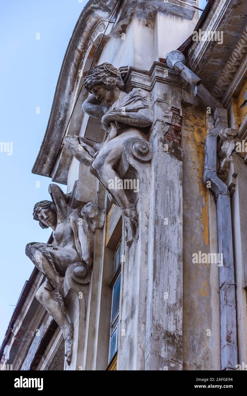 two statues adorn the facade of an old house Stock Photo - Alamy