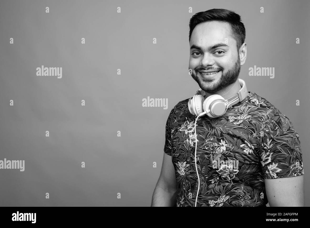 Indian young man wearing headphones Black and White Stock Photos ...