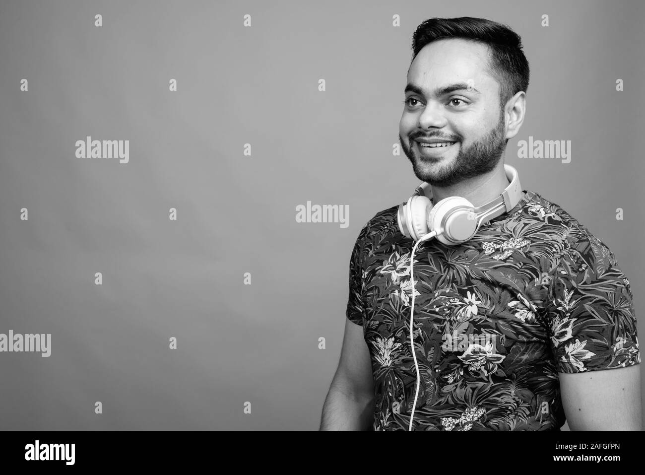 Indian young man wearing headphones Black and White Stock Photos ...