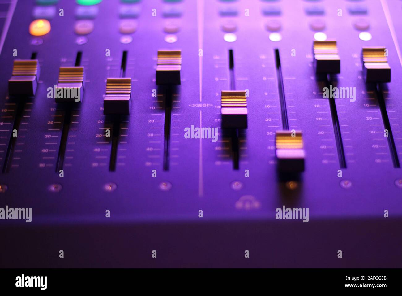 Closeup of a studio sound effect tools under neon lights with a blurry background Stock Photo