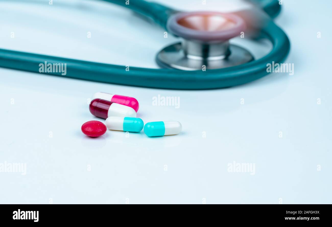 Stethoscope, capsule, and tablets pills on doctor table or nurse desk ...