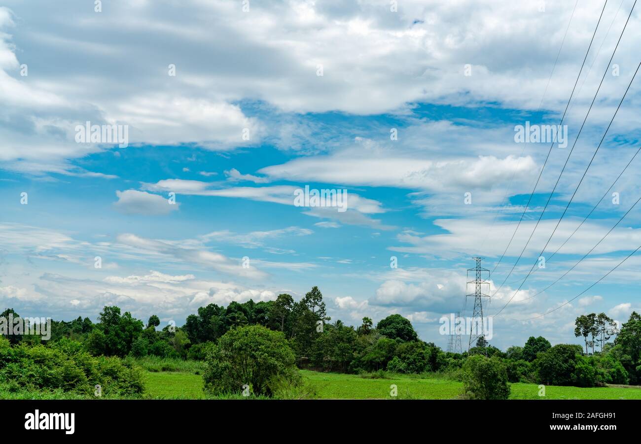 High voltage electric pylon and electrical wire with blue sky and white ...
