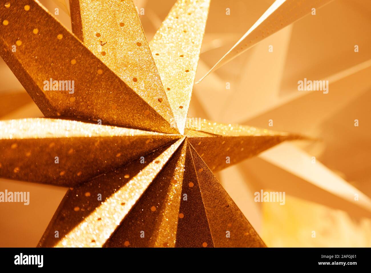 various Christmas stars in gold and cardboard to hang as decoration in the windows Stock Photo