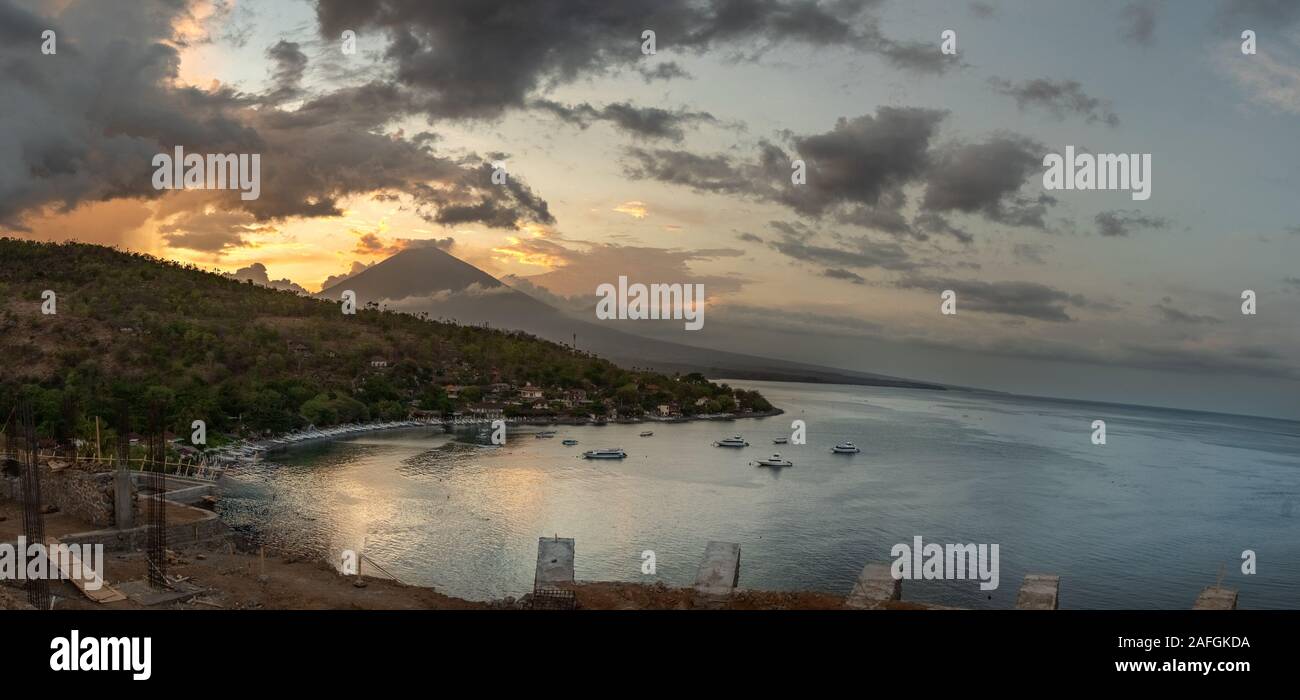 Colorful sunset with Mount Agung and Amed beach in Bali, Indonesia Stock Photo