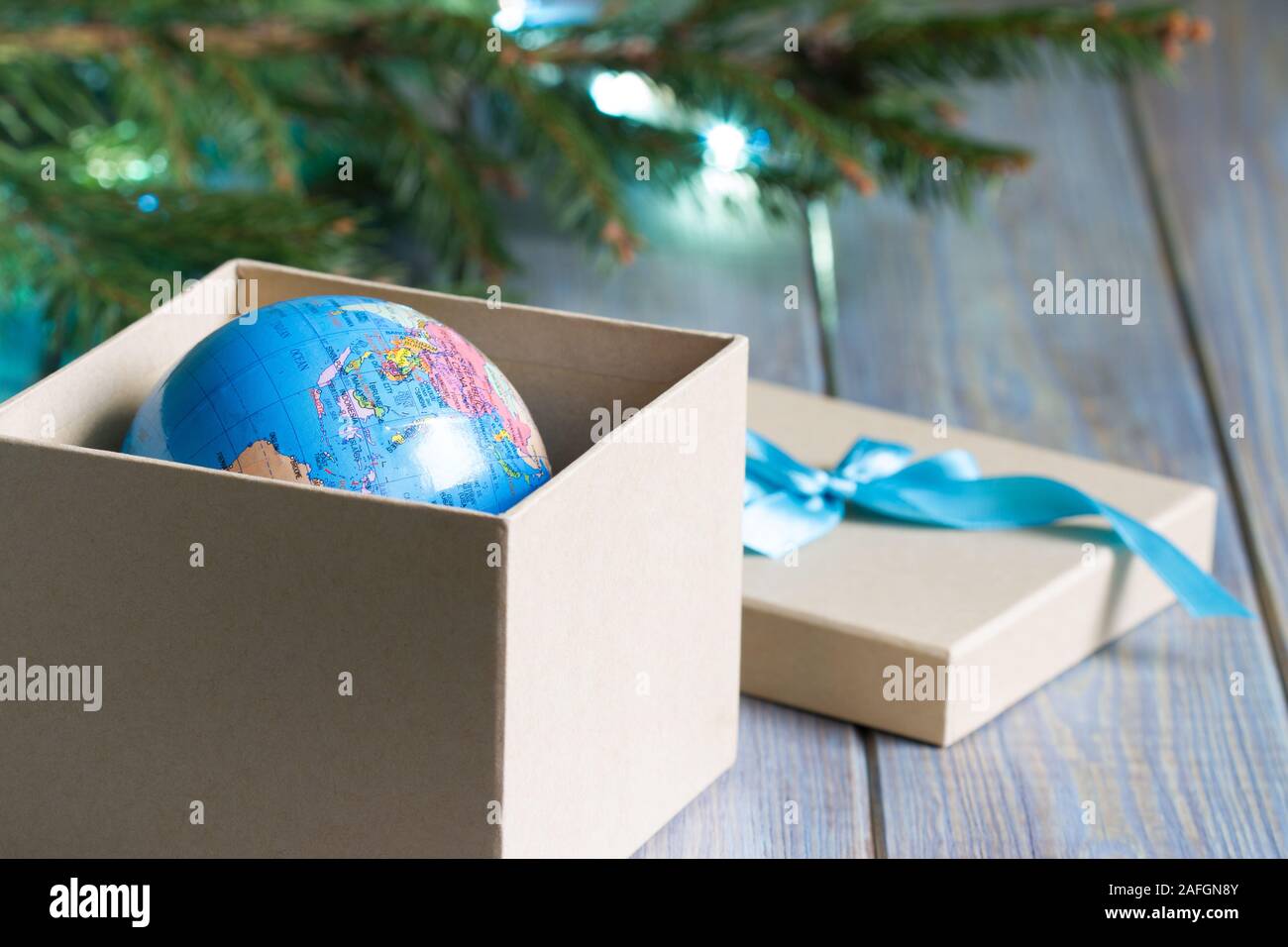 Globe in gift box. Travel gift for Christmas concept Stock Photo
