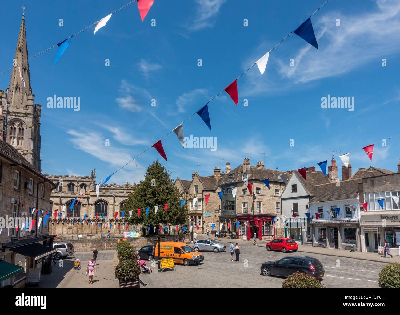 Red Lion Square in Stamford Town Centre with colourful bunting flags in summer with blue sky, Stamford, Lincolnshire, England, UK Stock Photo