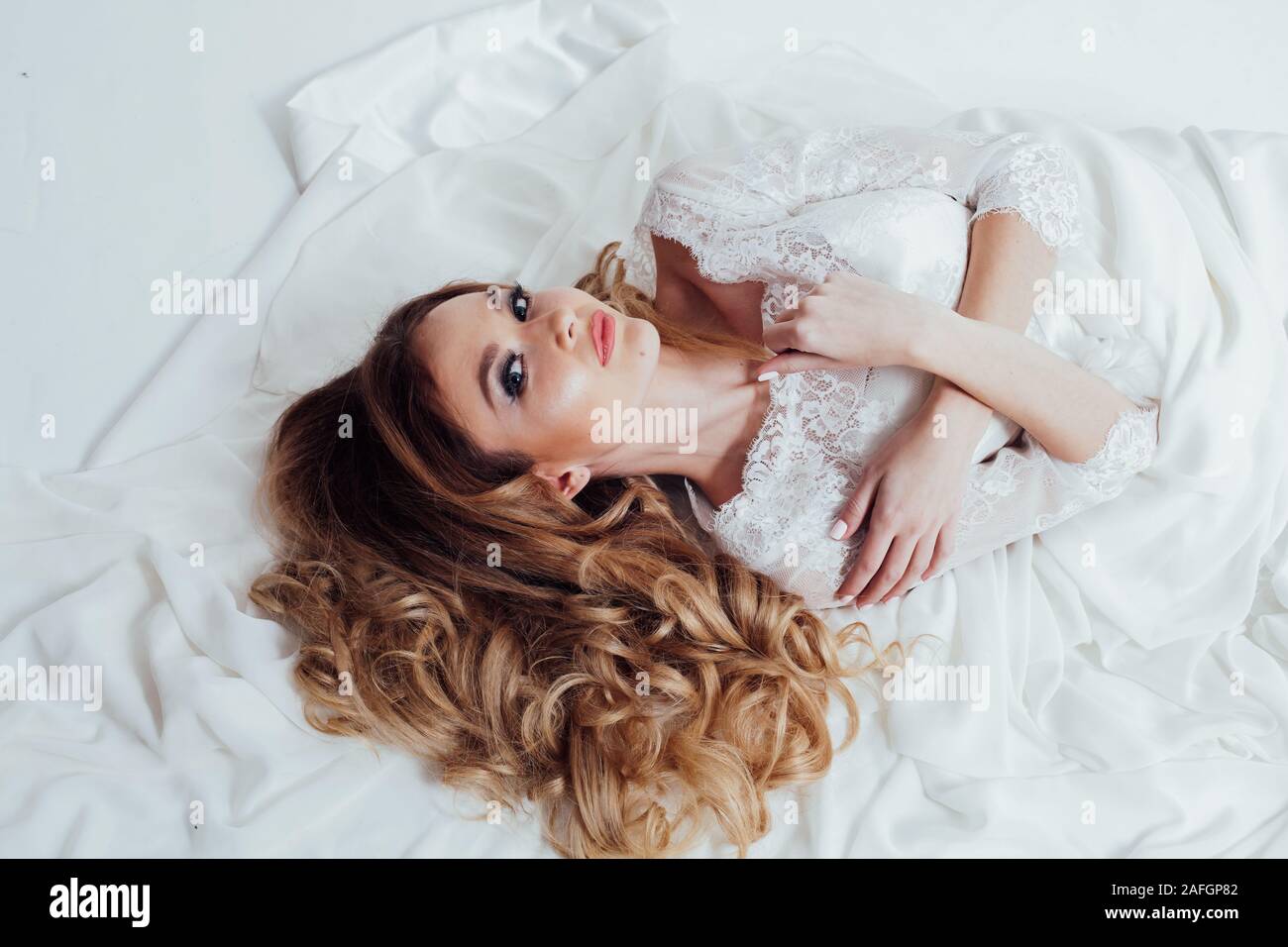 the bride in her wedding dress lay Stock Photo Alamy