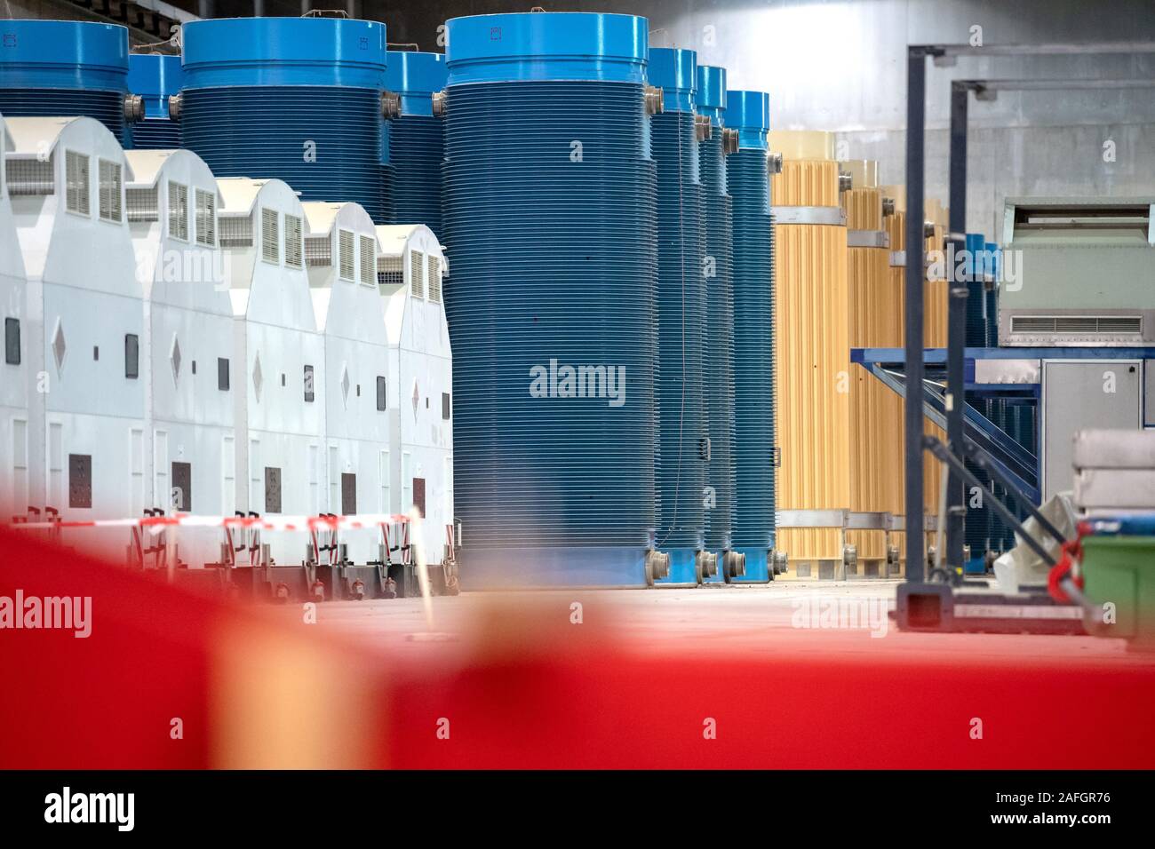 11 December 2019, Lower Saxony, Gorleben: Containers with high-level radioactive waste and transport hoods are in interim storage. The Gorleben nuclear waste storage facility is an interim storage facility for spent fuel elements and high-level radioactive waste. To date, 13 Castor transports with highly radioactive material have reached the transport container warehouse between 1995 and 2011. Until a repository has been found, the nuclear waste is to be temporarily stored there. Photo: Sina Schuldt/dpa Stock Photo