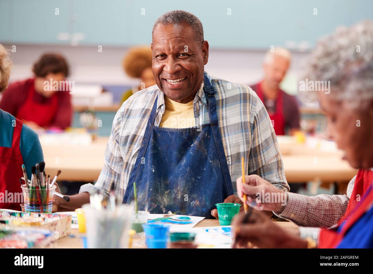 Portrait Of Retired Senior Man Attending Art Class In Community Centre