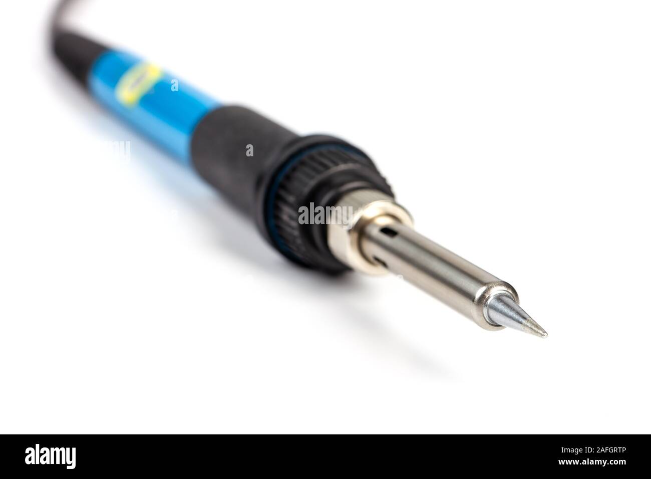 Close-up of a soldering iron tip with a blue handle on white background. Stock Photo