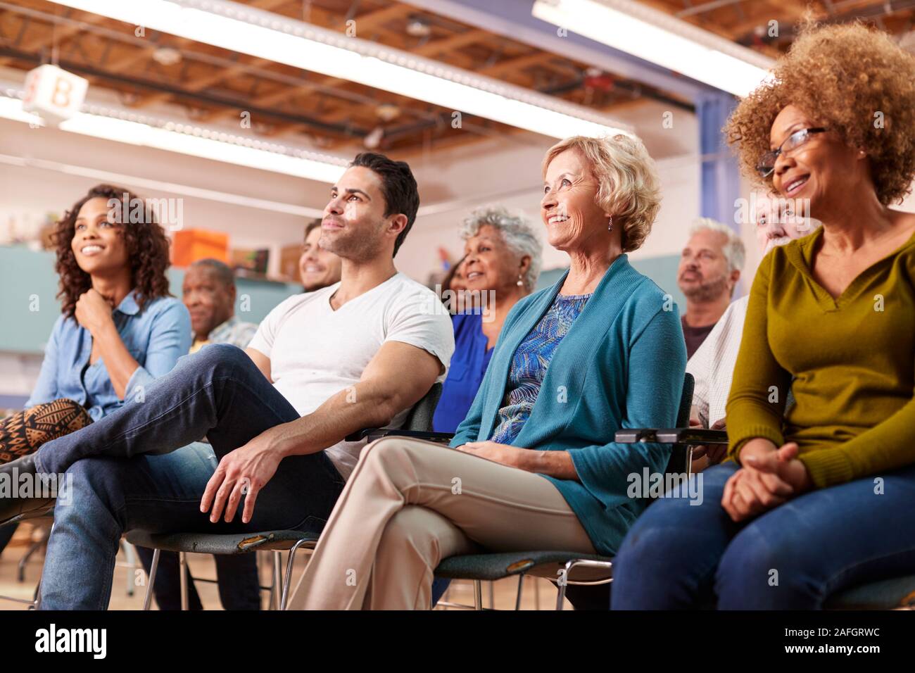 Group Attending Neighborhood Meeting In Community Center Stock Photo