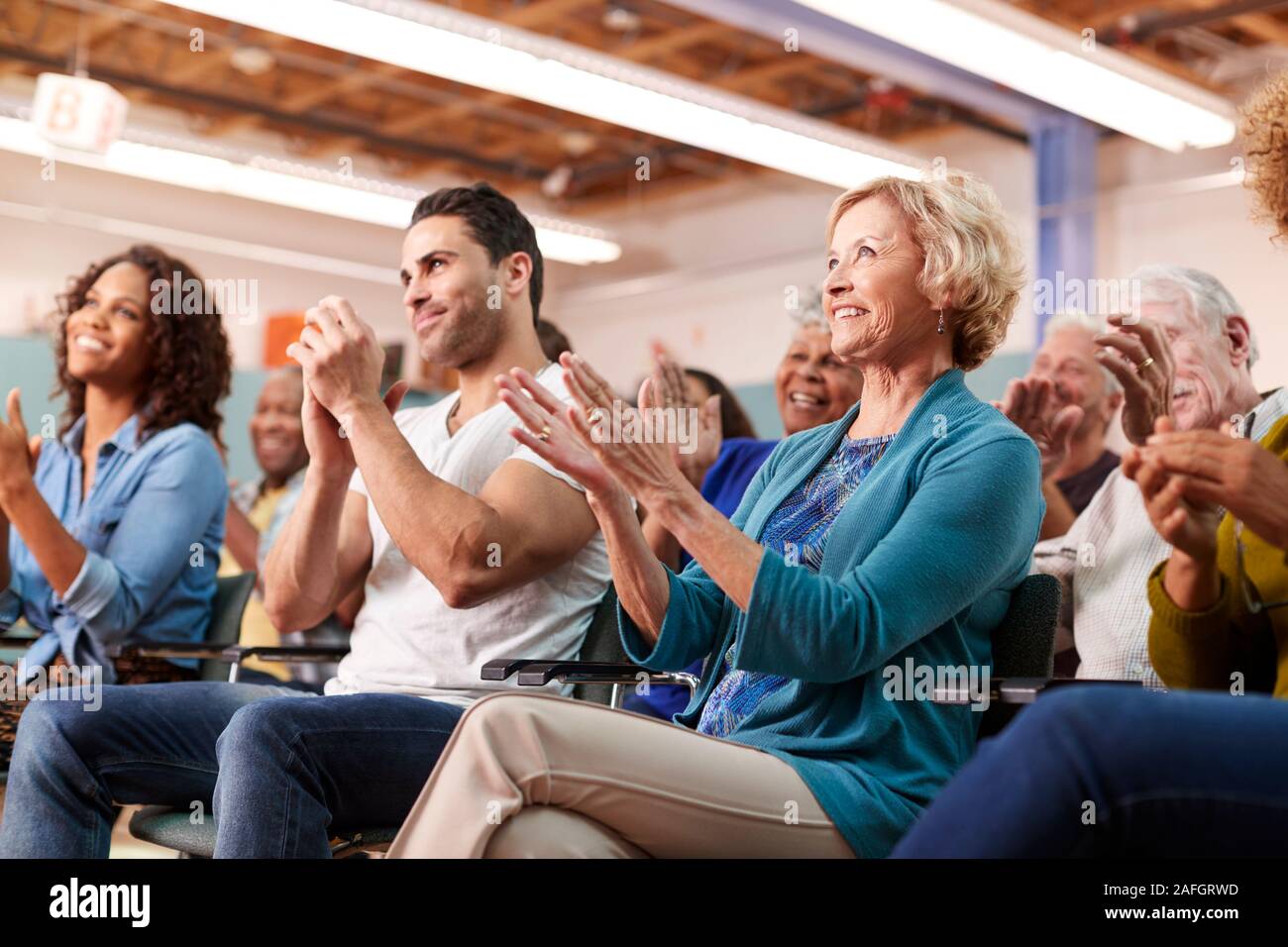 Group Attending Neighborhood Meeting In Community Center Clapping Stock ...