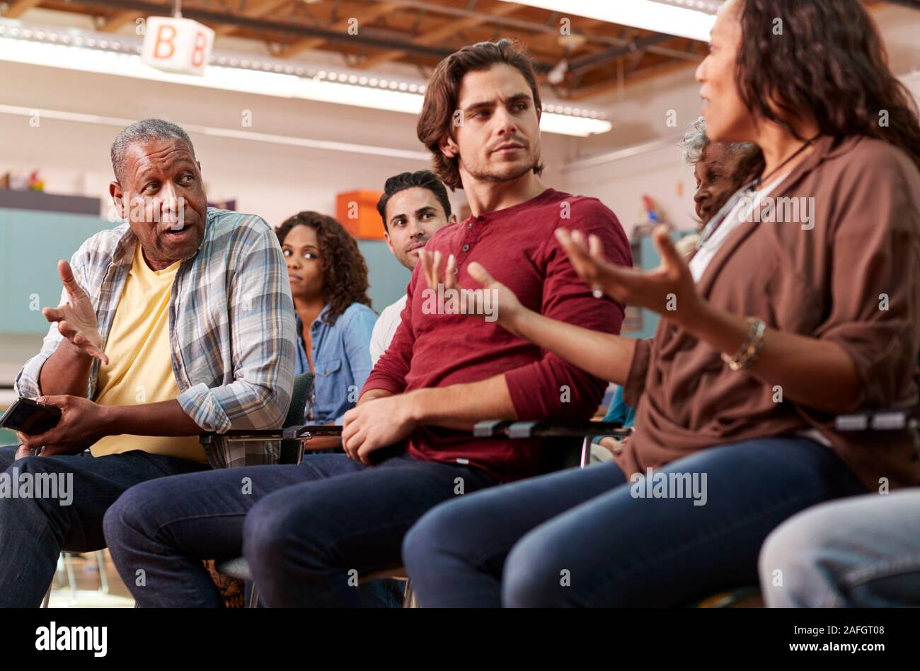 Group Attending Neighborhood Meeting In Community Center Stock Photo