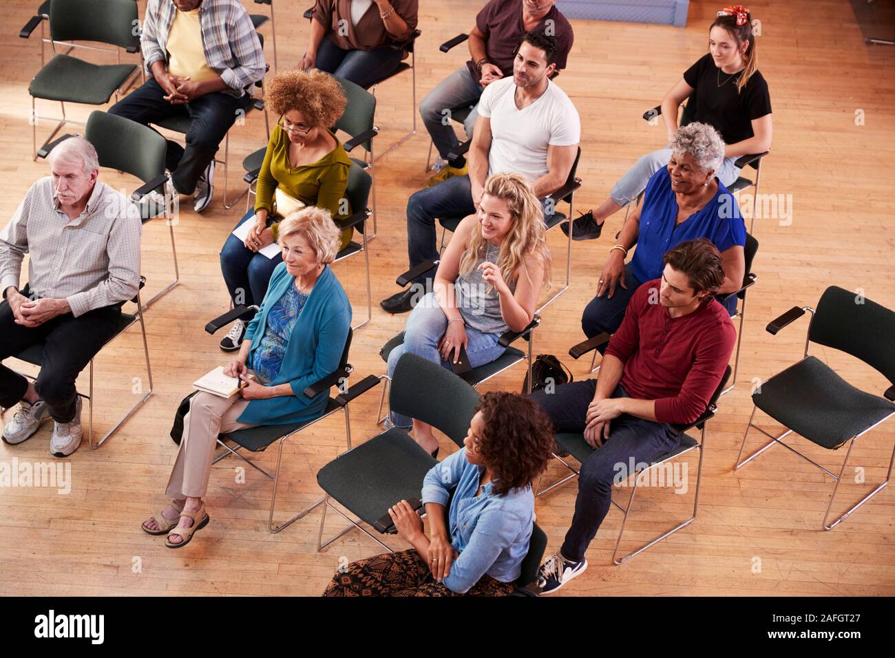 Overhead View Of Group Attending Neighborhood Meeting In Community Center Stock Photo