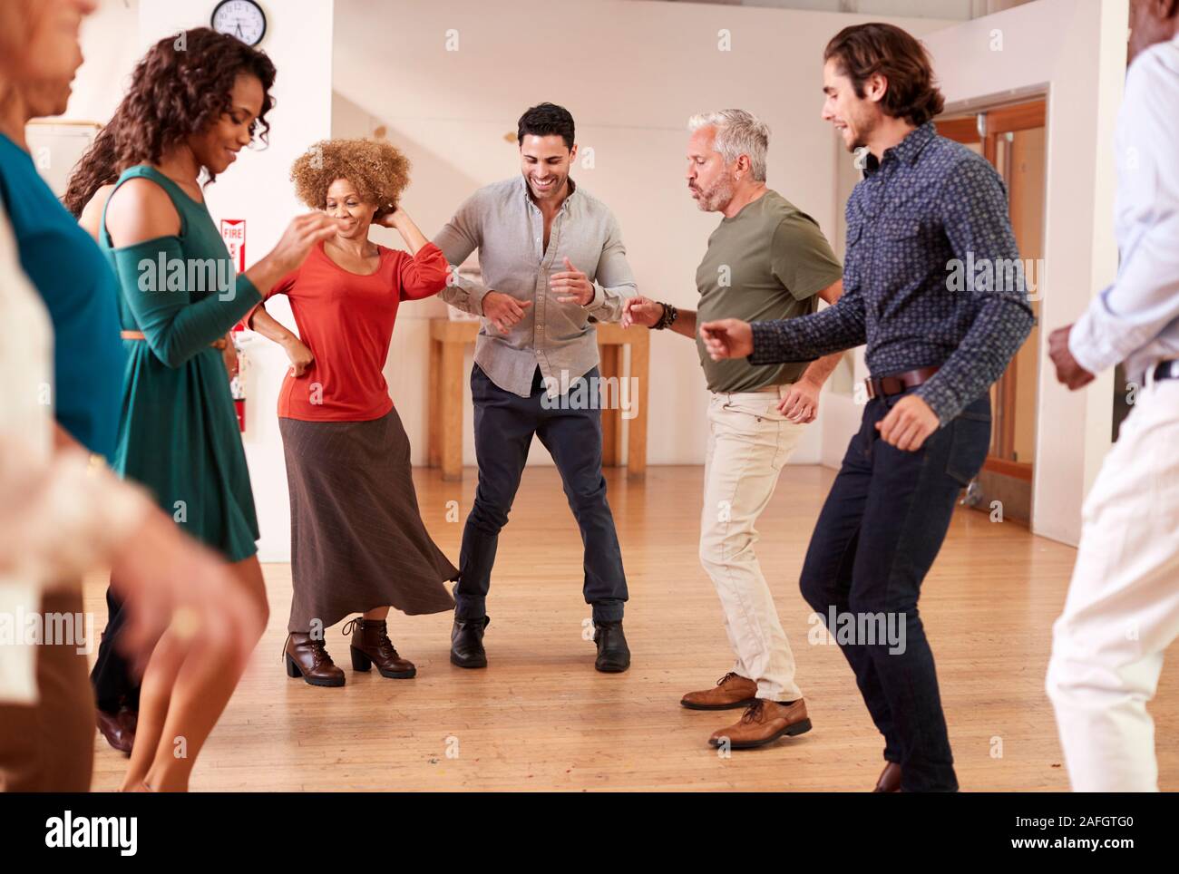 People Attending Dance Class In Community Center Stock Photo