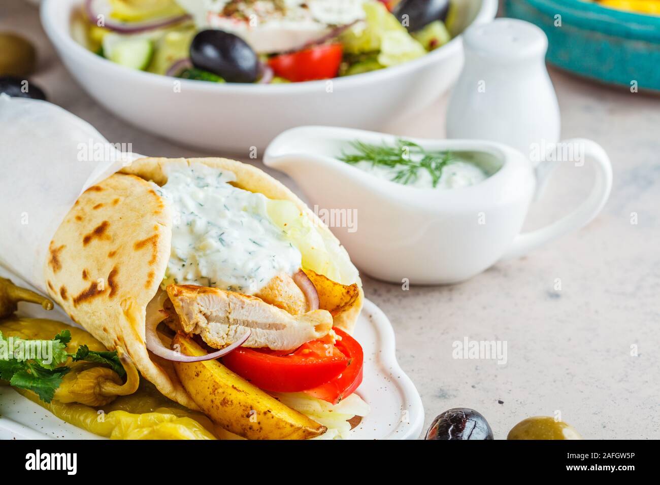 Chicken gyro pita with vegetables and sauce. Traditional greek cuisine concept. Stock Photo
