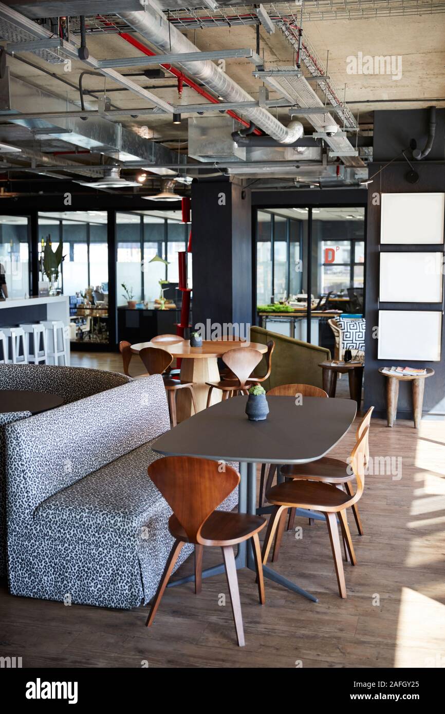 The eating and casual meeting area at a creative office in daylight, no people, vertical Stock Photo