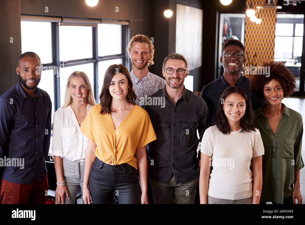 Portrait of a creative business team standing and smiling to camera in their office, elevated view Stock Photo