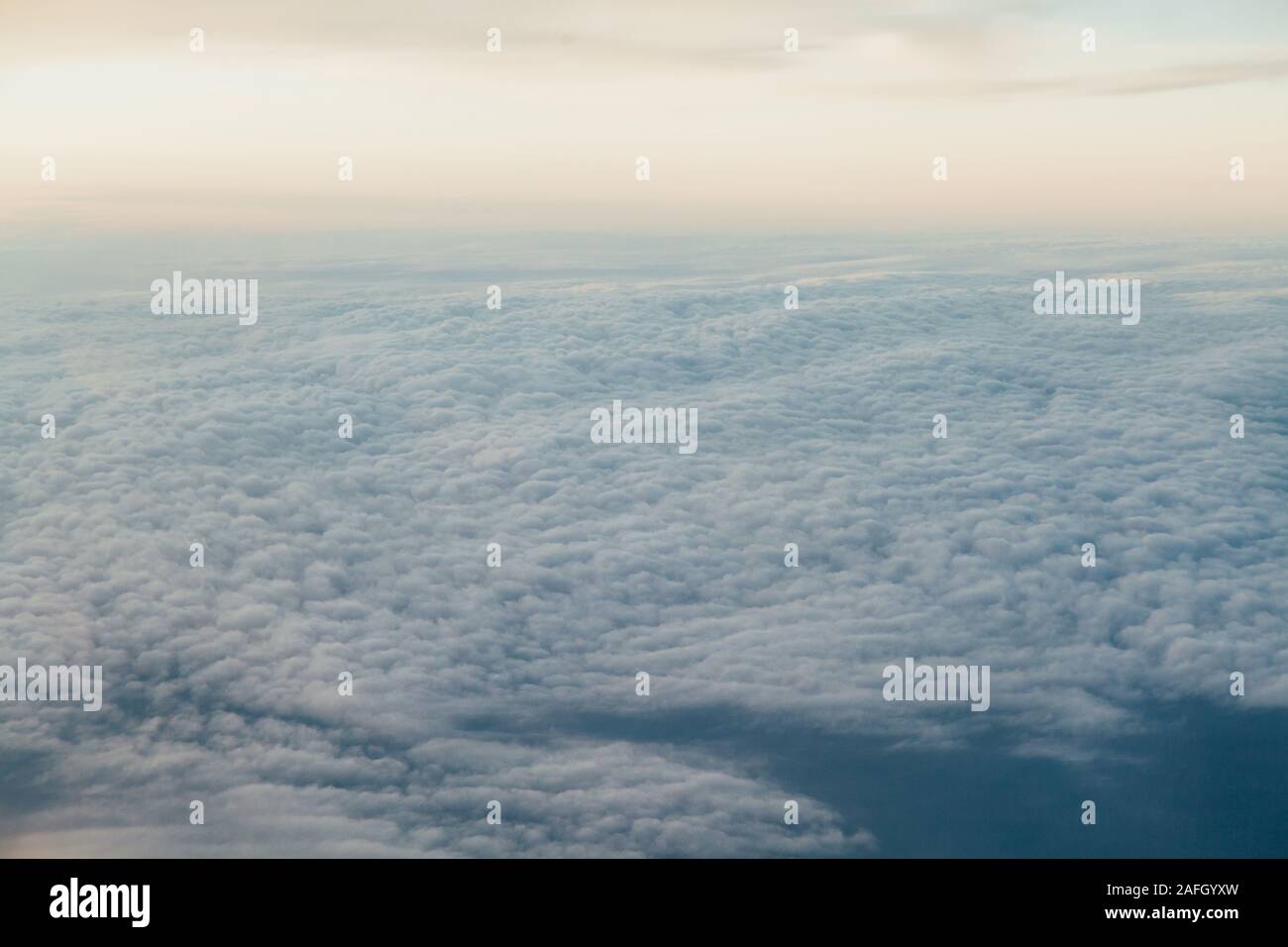 flying above the clouds at sunset landscape from an airplane Stock ...