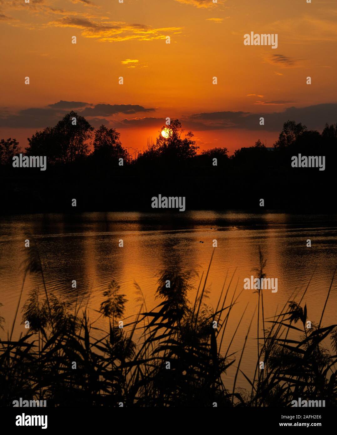 Beautiful scenery of the sunset reflecting in the lake Stock Photo - Alamy