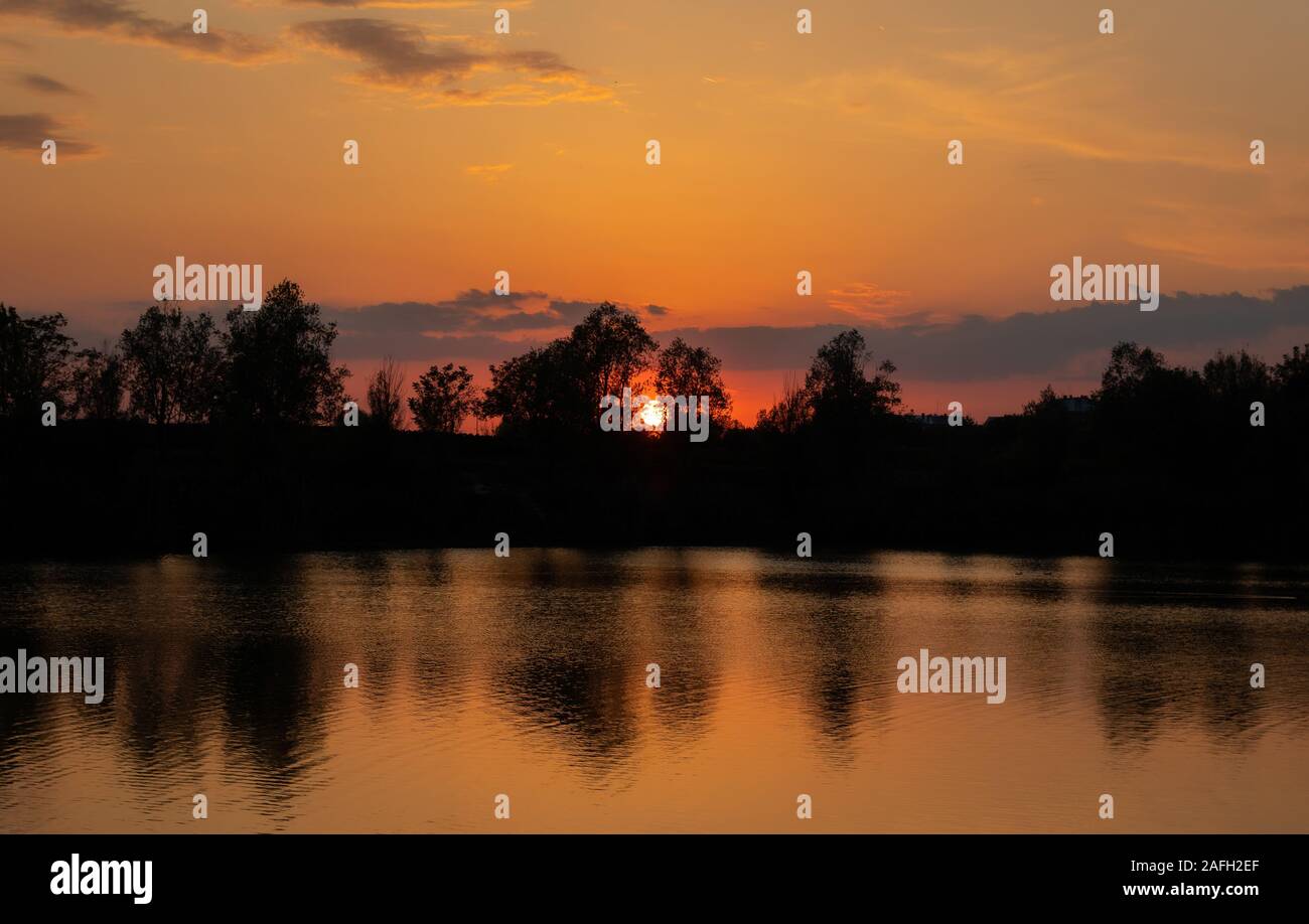 Beautiful scenery of the sunset reflecting in the lake Stock Photo - Alamy