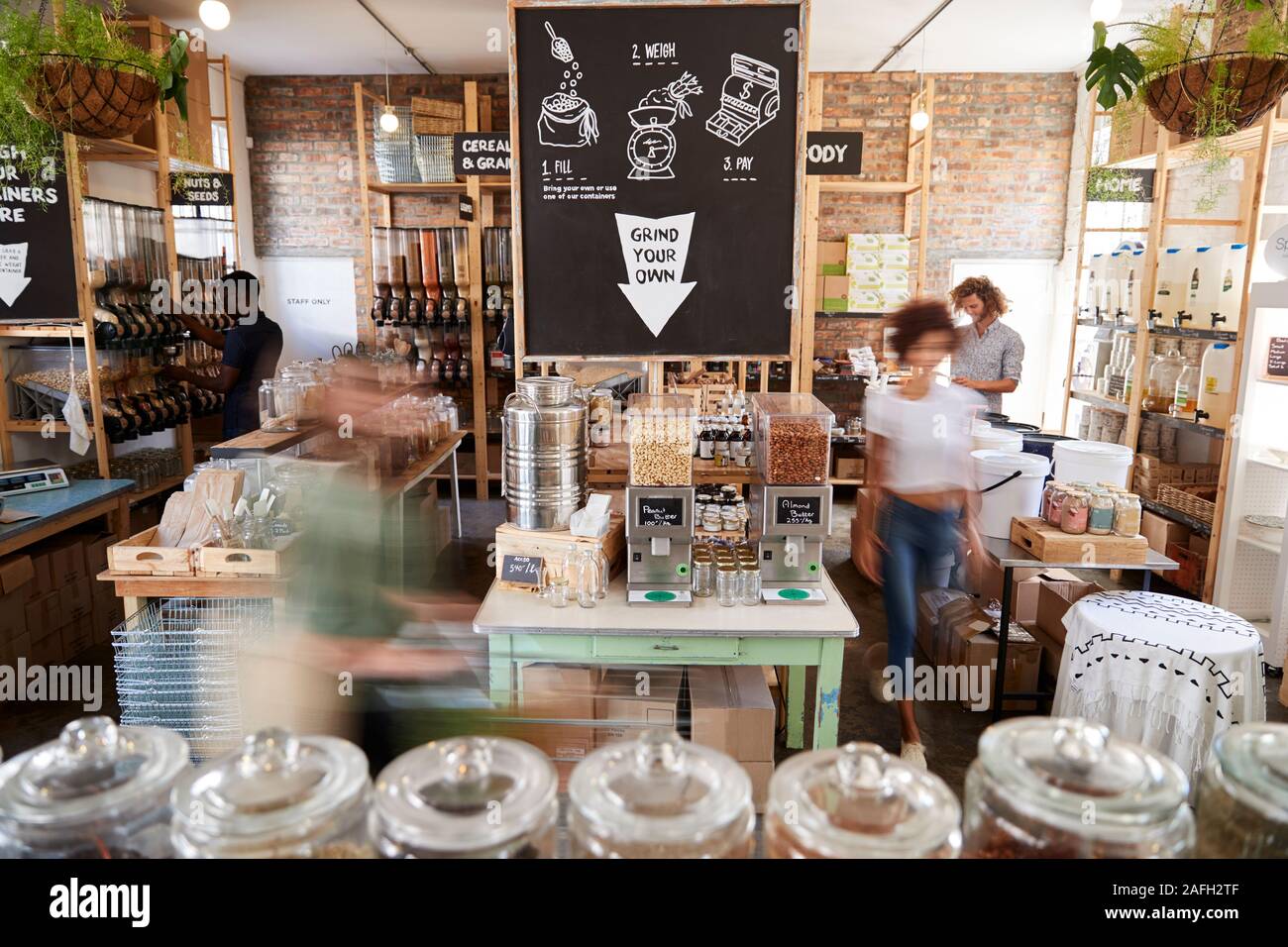 Shoppers Buying Fresh Fruit And Vegetables In Sustainable Plastic Free