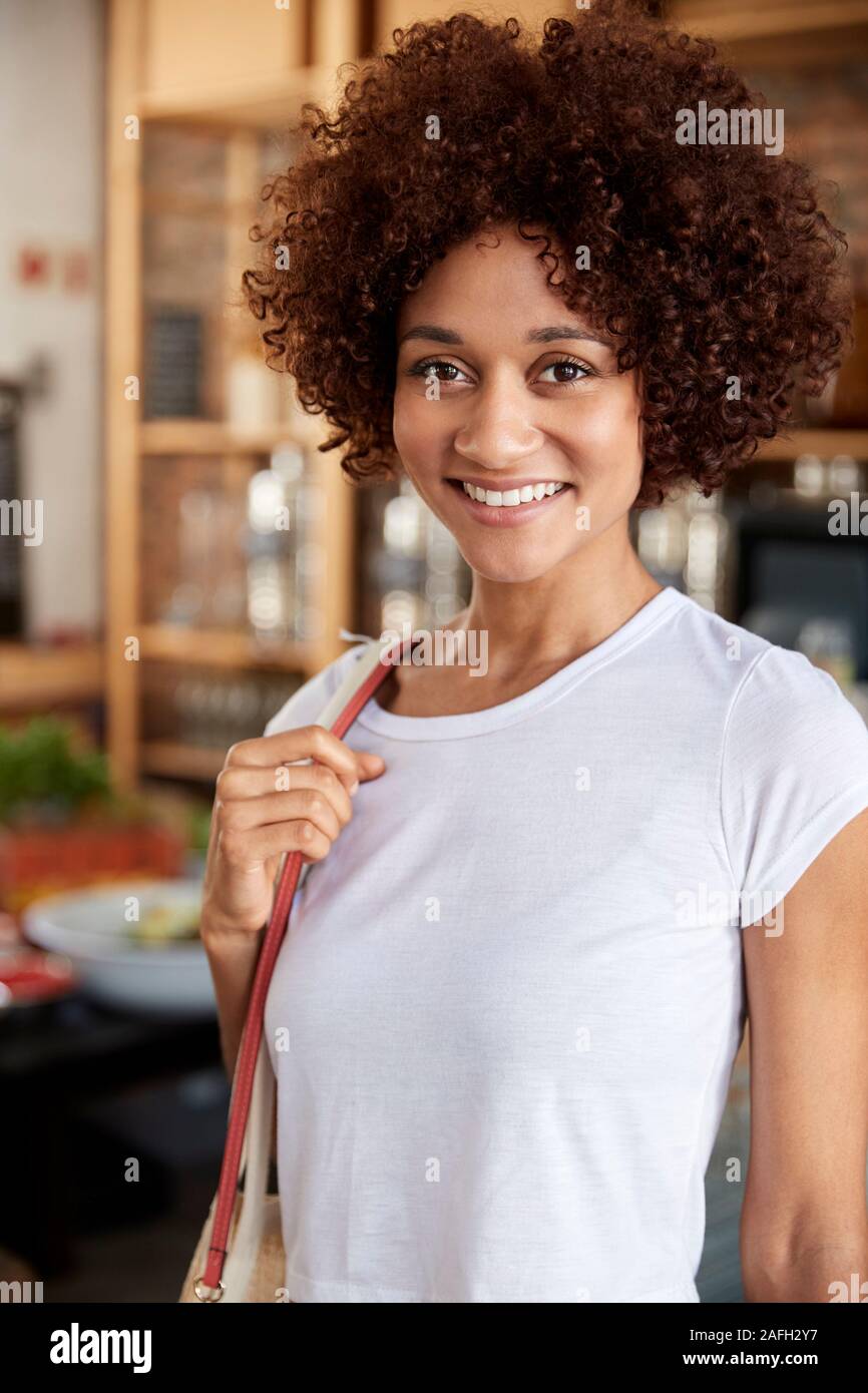 Portrait Of Woman Shopping In Sustainable Plastic Free Grocery Store Stock Photo