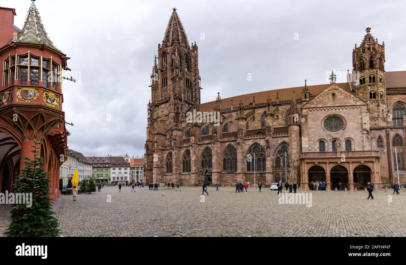 Freiburg, Baden-Wuerttemberg / Germany - 15. December, 2019: view of tourists visiting the cathedral and minster in Freiburg in the Breisgau Stock Photo