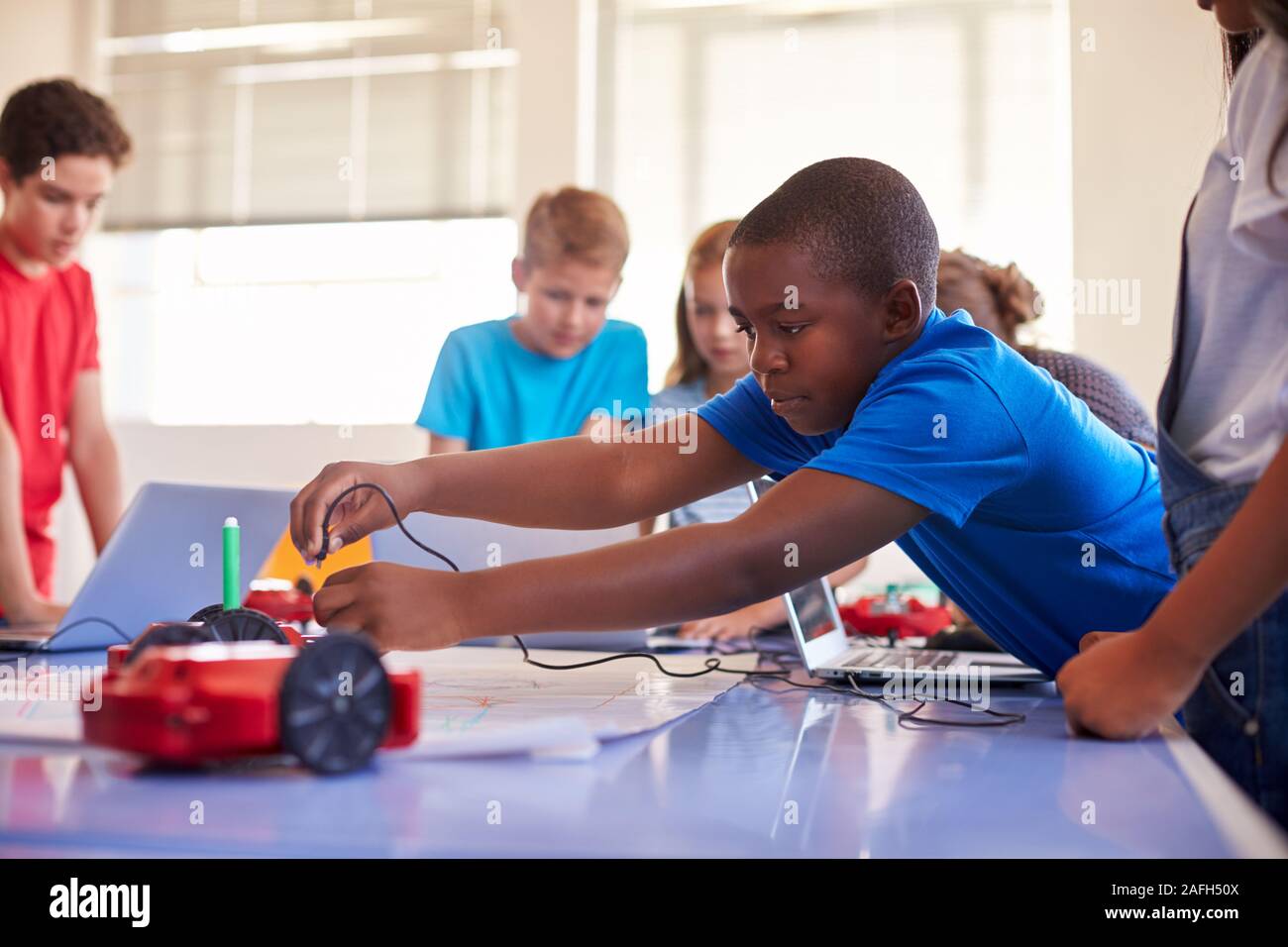 Group Of Students In After School Computer Coding Class Learning To ...