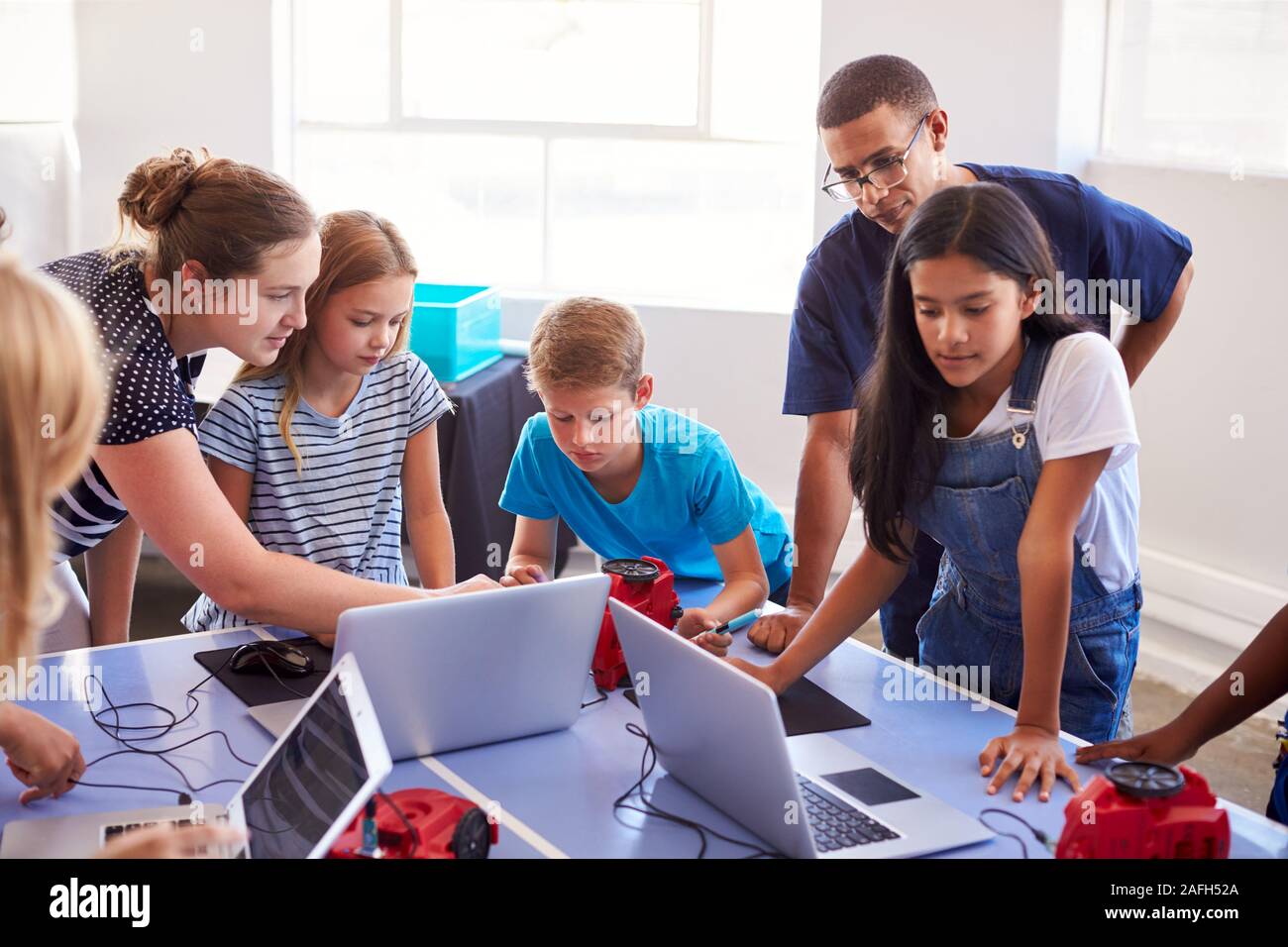 Group Of Students In After School Computer Coding Class Learning To ...