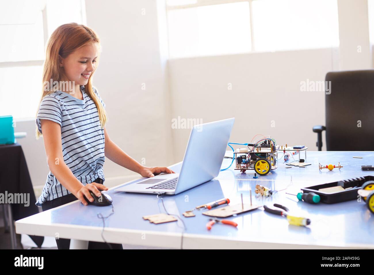 Female Student Building And Programing Robot Vehicle In After School Computer Coding Class Stock Photo