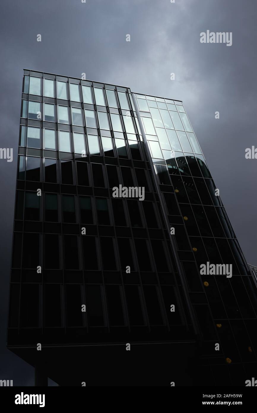 Vertical low angle shot of a high rise building in a glass facade under ...