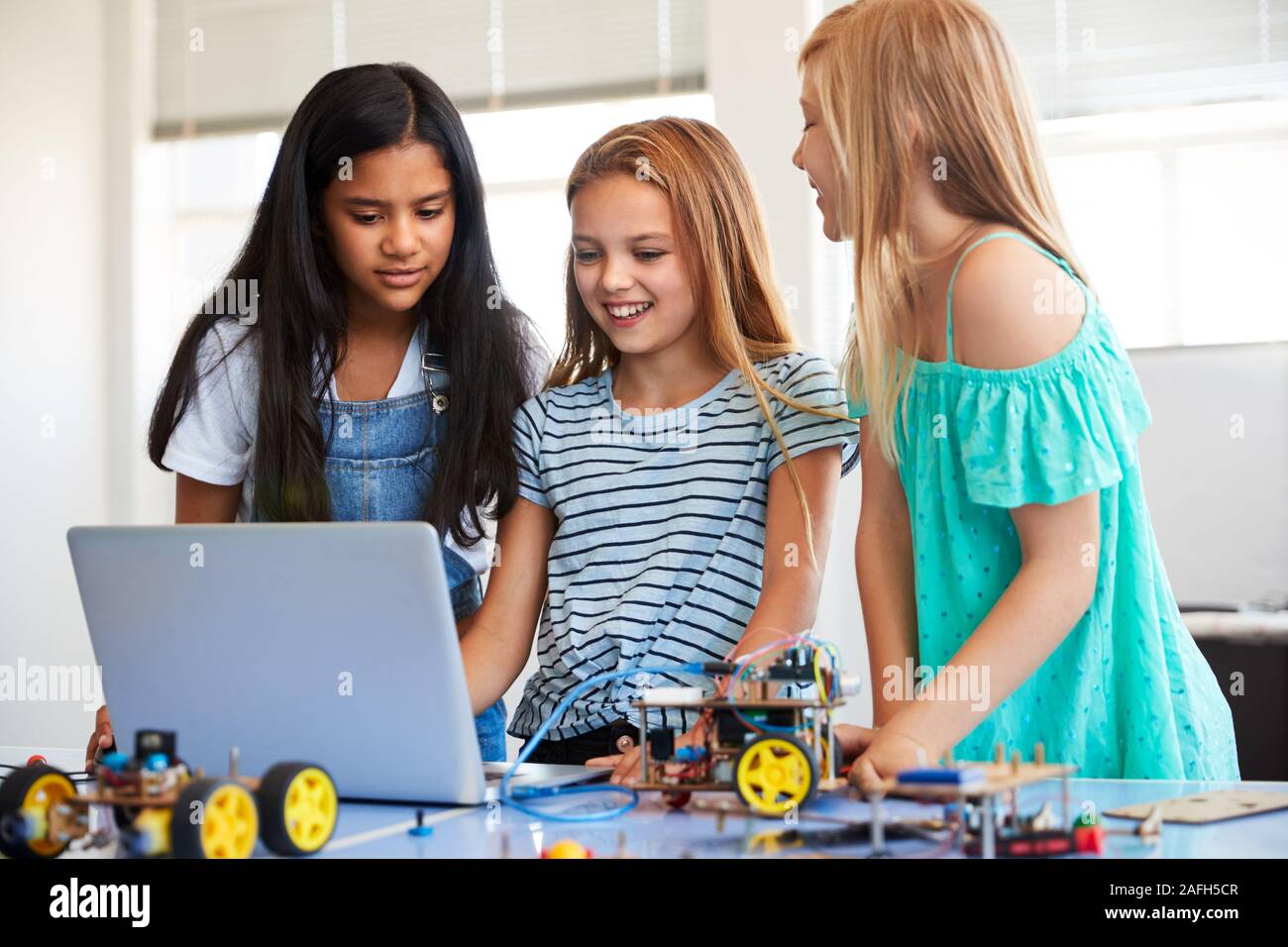 Three Female Students Building And Programing Robot Vehicle In After ...