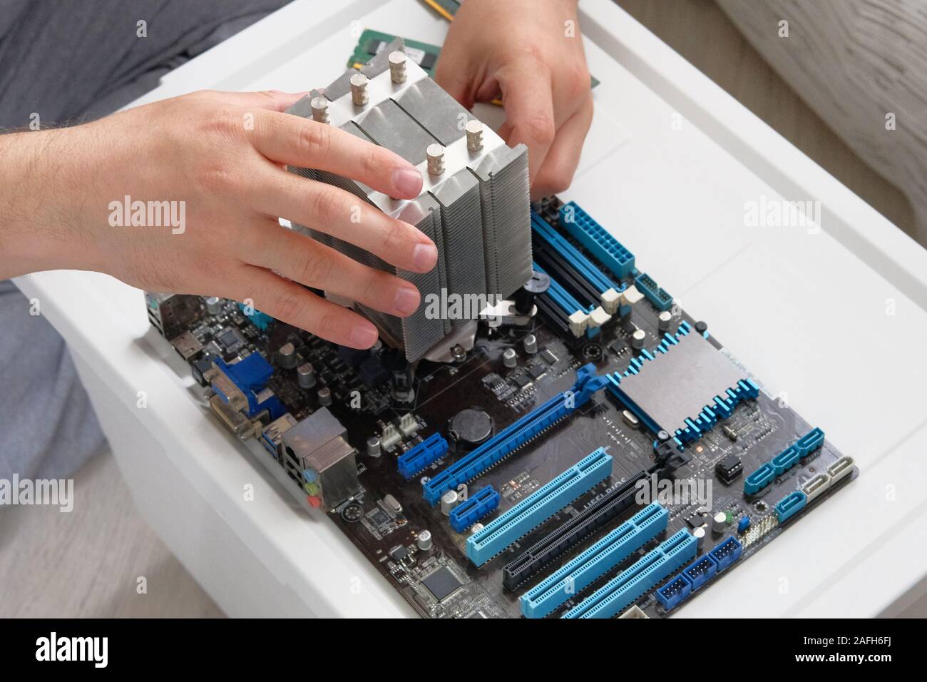 Hands of technician is repairing PC. Service electronics and computers concept. Stock Photo