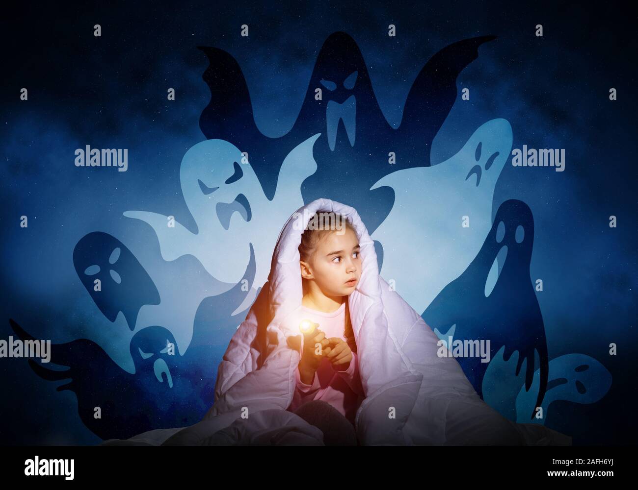 Scared girl with flashlight under blanket Stock Photo Alamy
