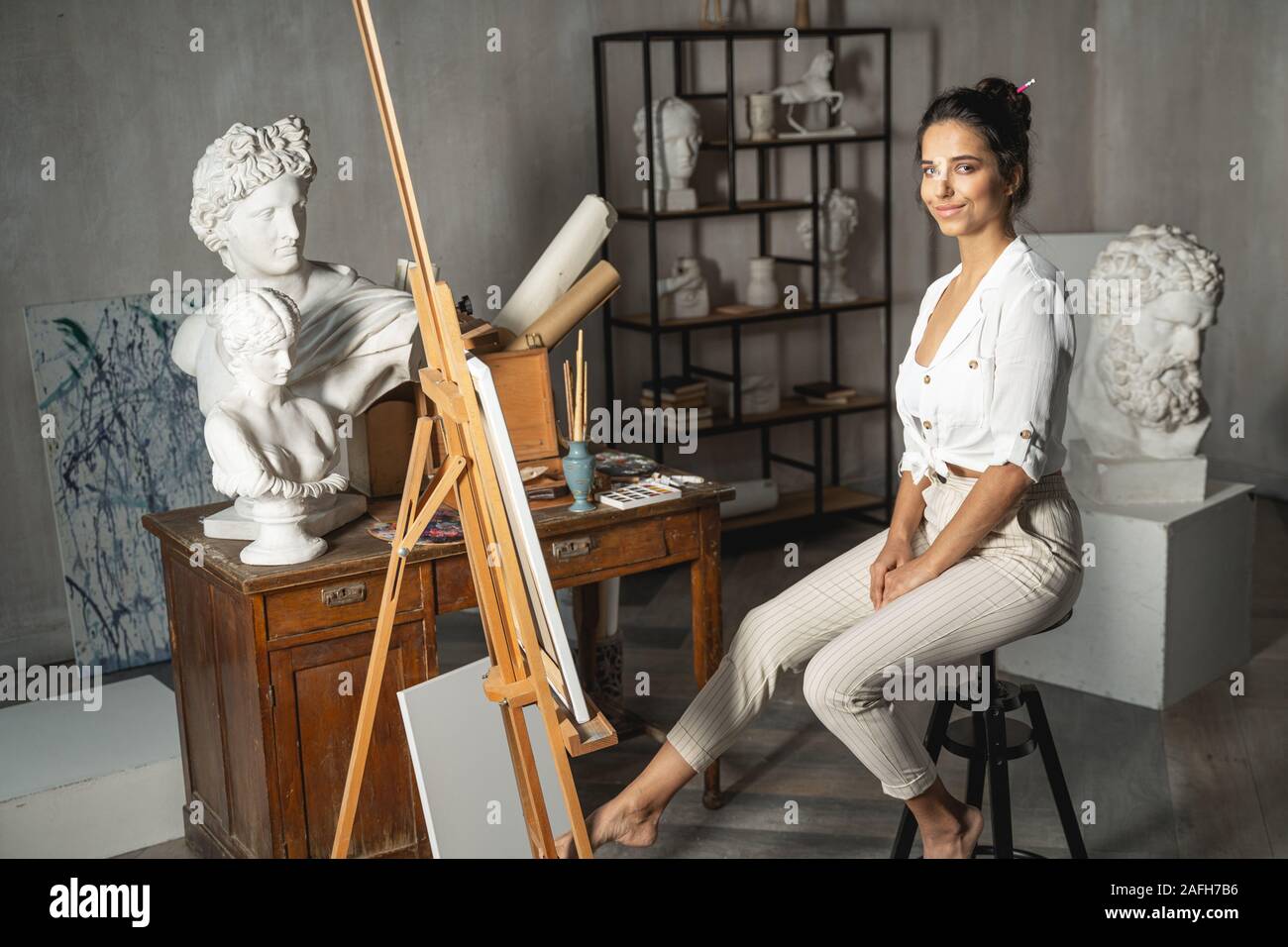 Happy nice lady posing for camera in art room Stock Photo - Alamy