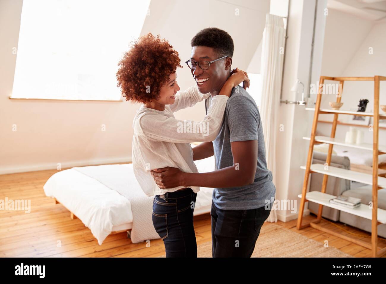 Couple Having Fun In New Home Dancing Together Stock Photo - Alamy