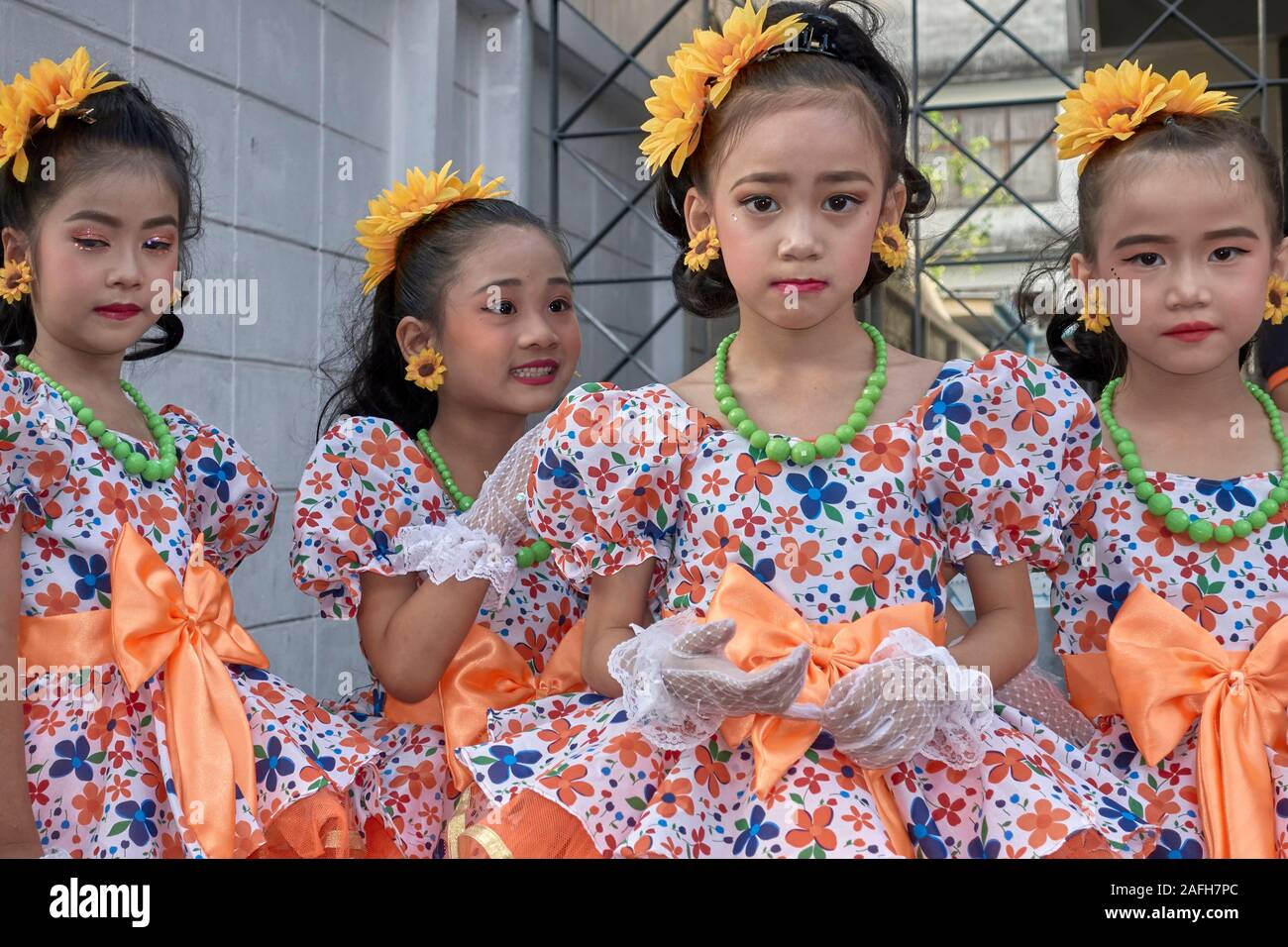Thailand dancers. Young girls in costume and wearing flowers in their hair, preparing to dance at a festival Stock Photo