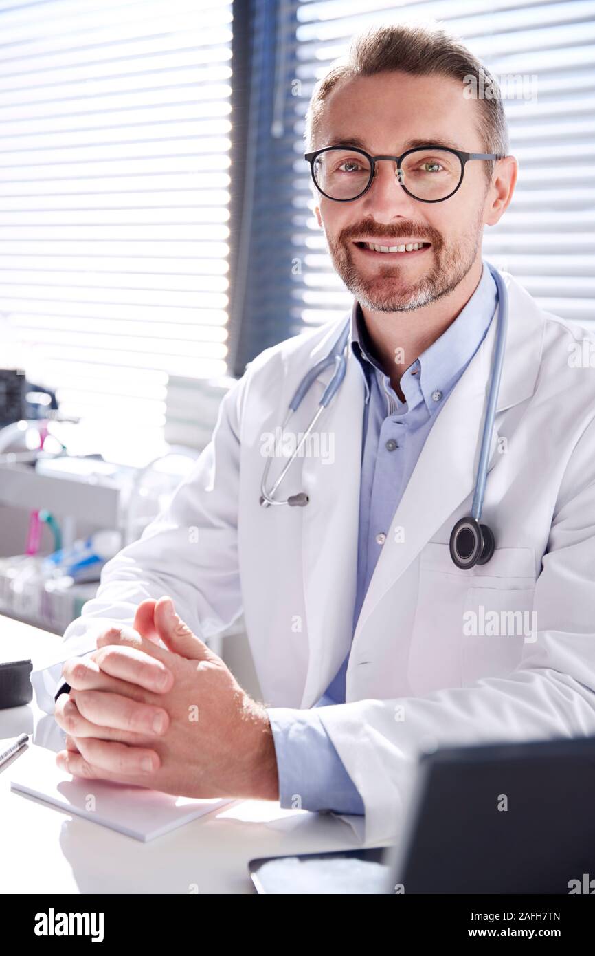 Portrait Of Smiling Male Doctor Wearing White Coat With Stethoscope