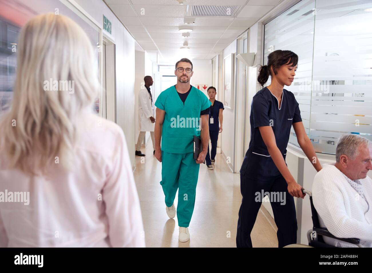 Busy Hospital Corridor With Medical Staff And Patients Stock Photo