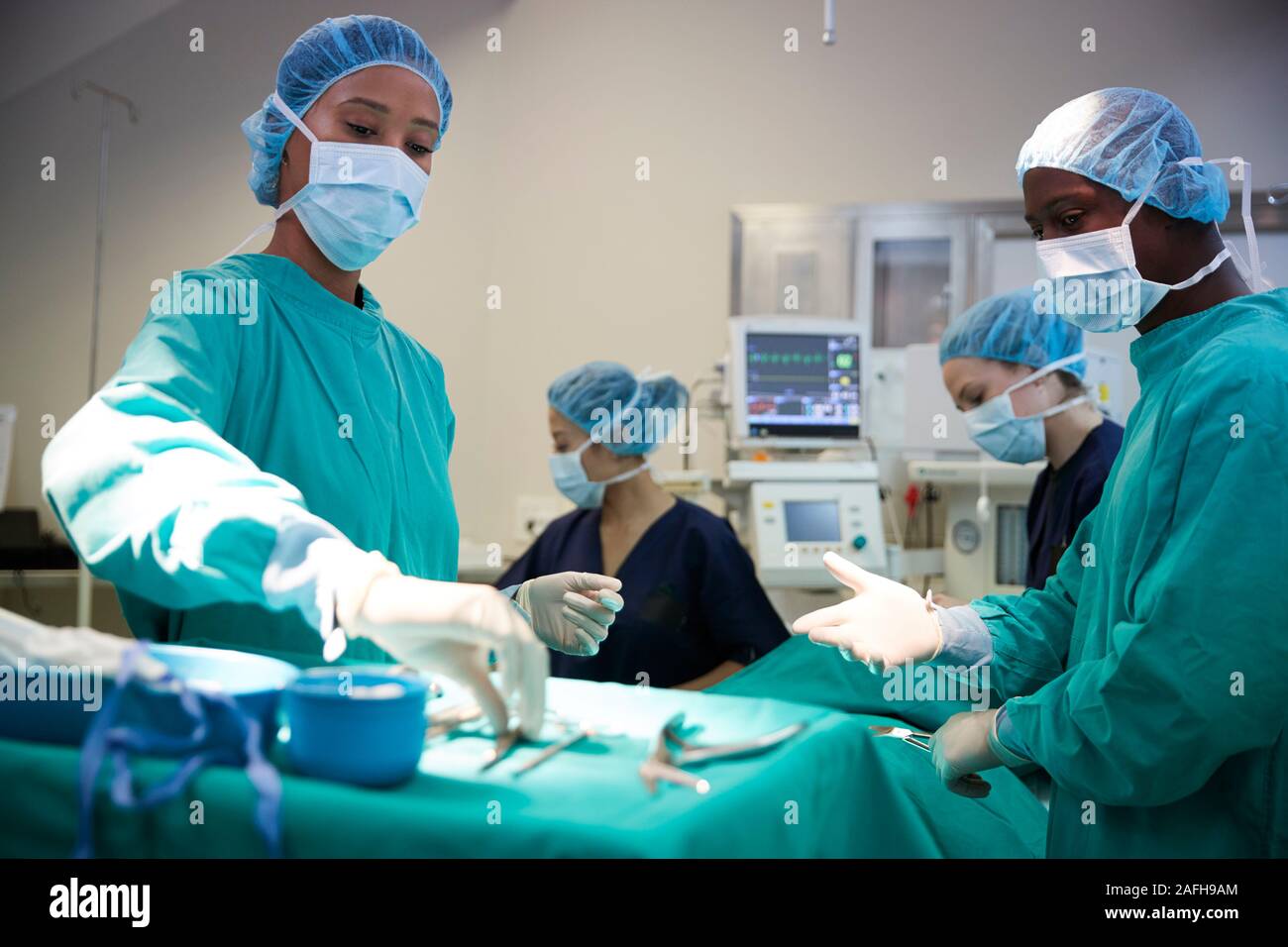 Surgical Team Working On Patient In Hospital Operating Theatre Stock Photo