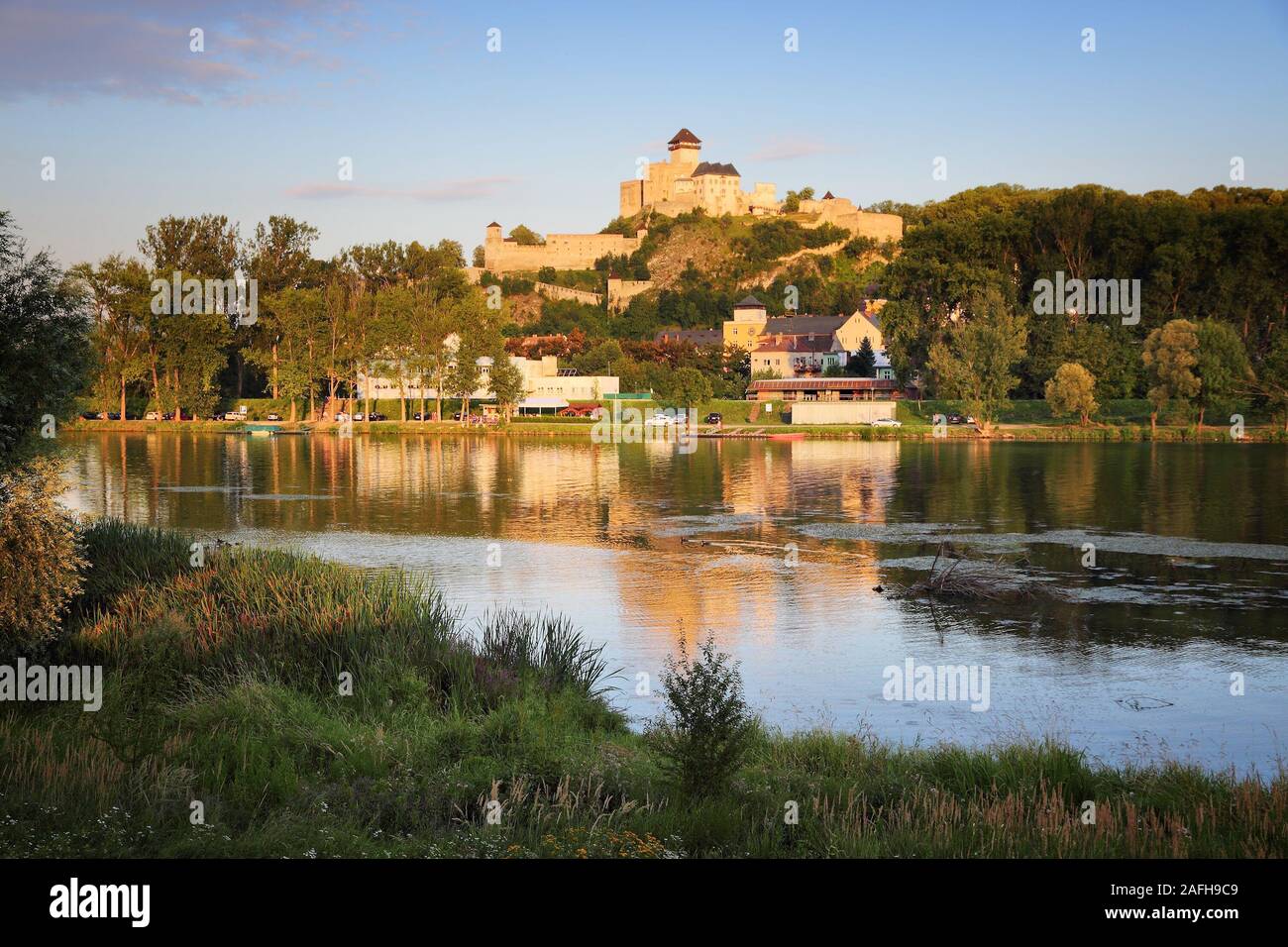 Trencin, Slovakia - sunset view with Vah river and the Castle. Stock Photo